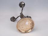 a silver plate sitting on top of a silver plate