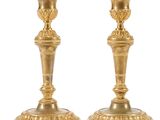 paire de chandeliers anciens en laiton sur piédestal sur fond blanc