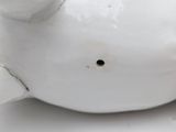 a white pig figurine sitting on a white surface