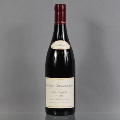 the bottle of red wine is sitting on the table
