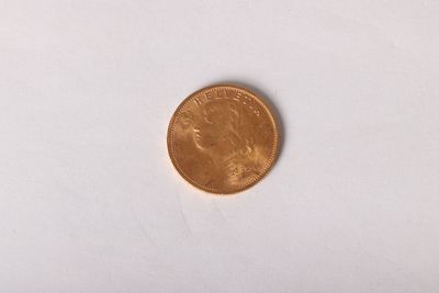 a close up of a penny on a white surface with a white background