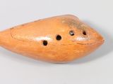 a small wooden object with holes in it