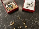 two pairs of earrings and a ring in a red box on a table