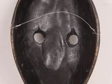 a close up of a black mask on a white background