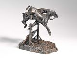 bronze statue of a horse and rider on a rock with a white background