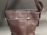 a brown leather purse with a strap on the side of it