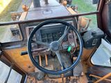 a steering wheel and dashboard of a tractor
