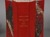 an open book with a red cover and a black and white design