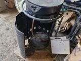 a pile of junk on the ground next to a trash can