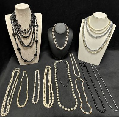 many necklaces and bracelets on display on a table