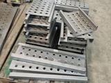 several pieces of metal are stacked on pallets in a warehouse