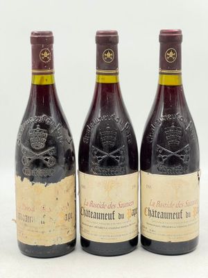 trois bouteilles de vin posées les unes à côté des autres sur une surface blanche