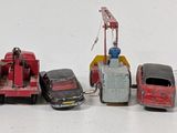 several toy cars are lined up in a row on a white surface