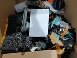 a cardboard box filled with assorted electronics and wires