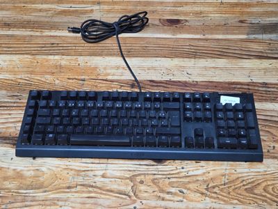 a computer keyboard and mouse sitting on a wooden table