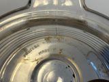 a close up view of a silver plate with a clock on it