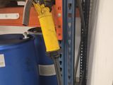 a blue barrel with a yellow handle next to a blue barrel with a yellow handle