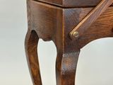 a small wooden table with a drawer on top of it