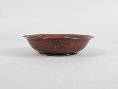 a brown bowl sitting on top of a white surface