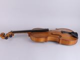 an old violin sitting on top of a white surface