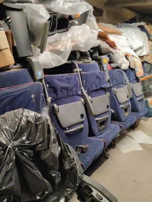 many bags of luggage sitting on the seats of an airplane