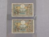 two different types of bank notes are on display on a table