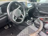 the interior of a car with a steering wheel and dashboard controls