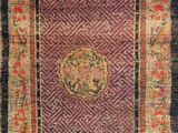 an antique persian rug with a medallion design on a purple ground
