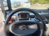 a car dashboard with a steering wheel and a gps device