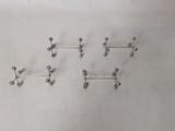 five pairs of silver balls on a white surface
