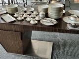 many plates and bowls on a table in a room