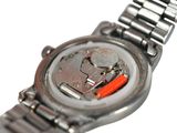 a close up of a watch on a white surface