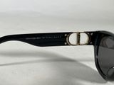 black sunglasses with a gold ring on the top of the glasses
