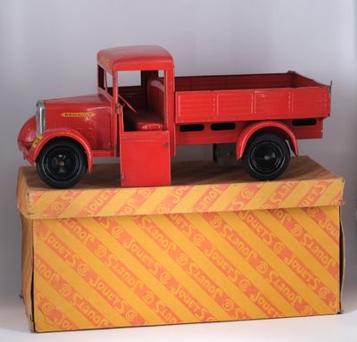 a red toy truck sitting on top of a box