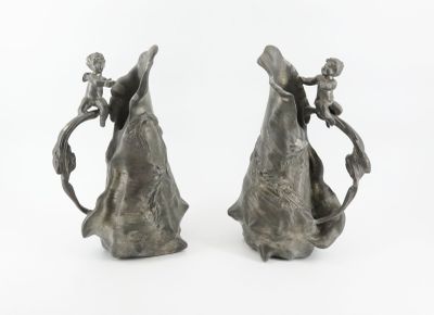 two vases that are sitting side by side on a white surface