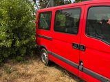 a red van that is parked next to a tower