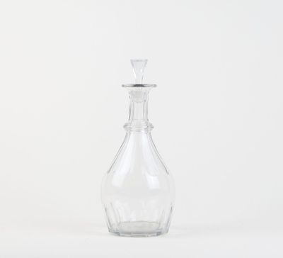 a clear glass bottle with a stopper on top of it