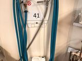 a blue hose attached to a water heater in a room