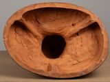 a clay vase with a hole in it on a table
