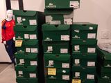 boxes stacked on top of each other in a room with a person standing in the background
