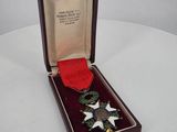 a small box with a red ribbon in it