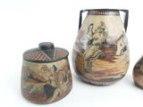 three vases with different designs on them on a white surface