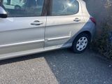 a small silver car parked on the side of the road