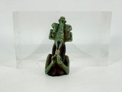 a small figurine of a man sitting on a rock