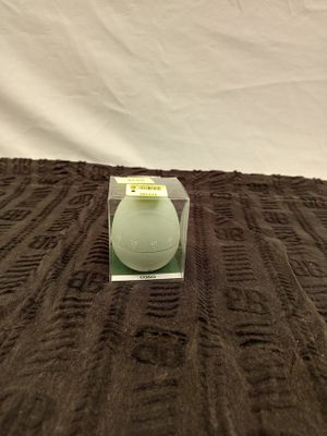 a white candle that is sitting on a brown blanket