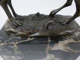 a statue of a horse on a marble base