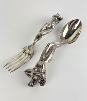 two spoons and a fork sitting on a table