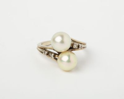 a white pearl and diamond ring on a white background