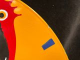 a close up of a yellow and red plate with a red rooster on it