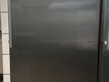 a stainless steel refrigerator in a kitchen with tile flooring